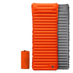 Orange and gray inflatable sleeping pad with a smaller orange sleeping pad on a white background