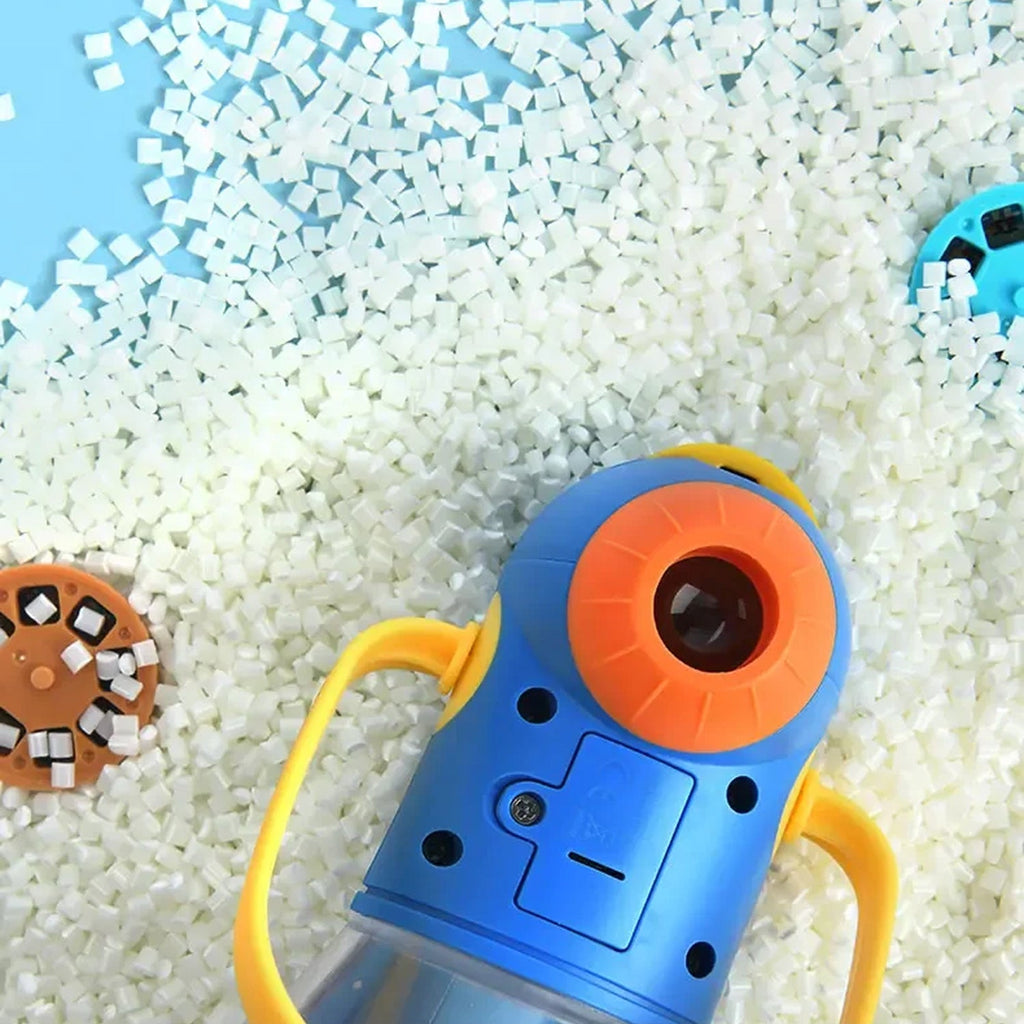 Toy camera with orange lens and yellow handles on a white and blue checkered background
