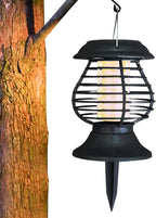 Black outdoor hanging light fixture attached to a tree