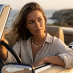 Woman driving a convertible car by the ocean