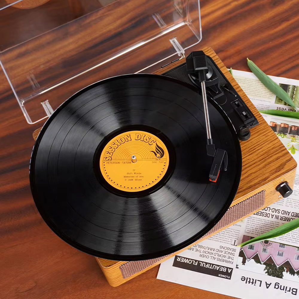 Wooden record player with a vinyl record on a wooden surface