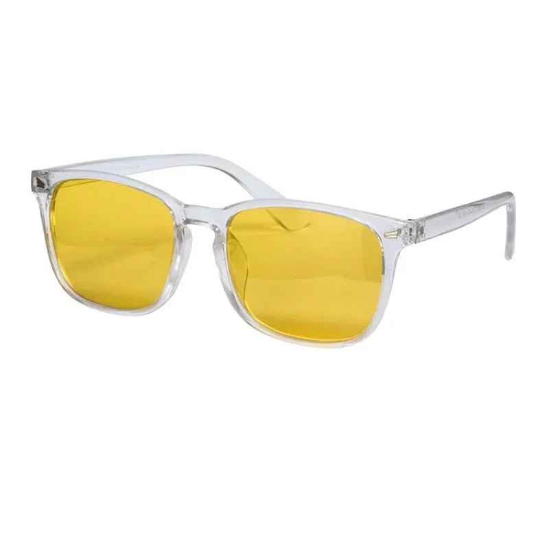 Sunglasses with yellow lenses and clear frames on a white background
