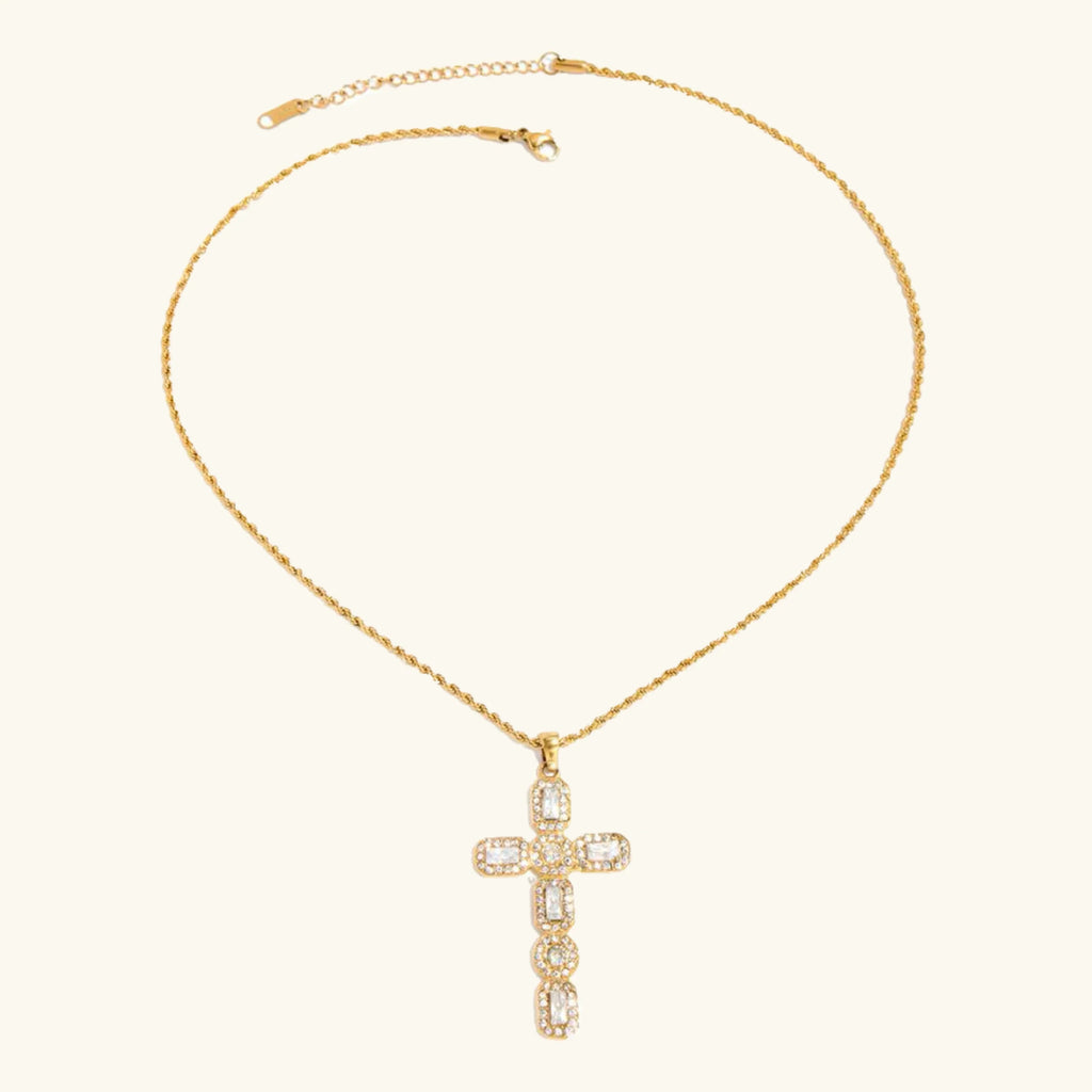 Gold necklace with a cross pendant on a white background