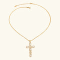 Gold necklace with a cross pendant on a white background