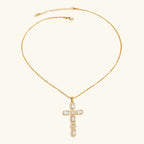 Gold necklace with a cross pendant on a white background