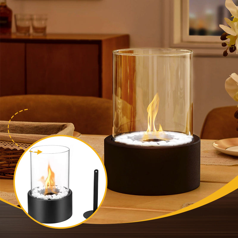 Tabletop fire pit with glass cover on a wooden surface, surrounded by a cozy indoor setting.