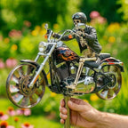 Skeleton figure on a motorcycle held by a hand with a blurred green background