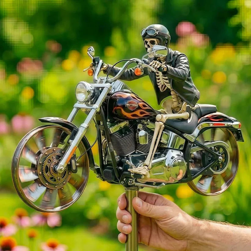 Skeleton figure on a motorcycle held by a hand with a blurred green background