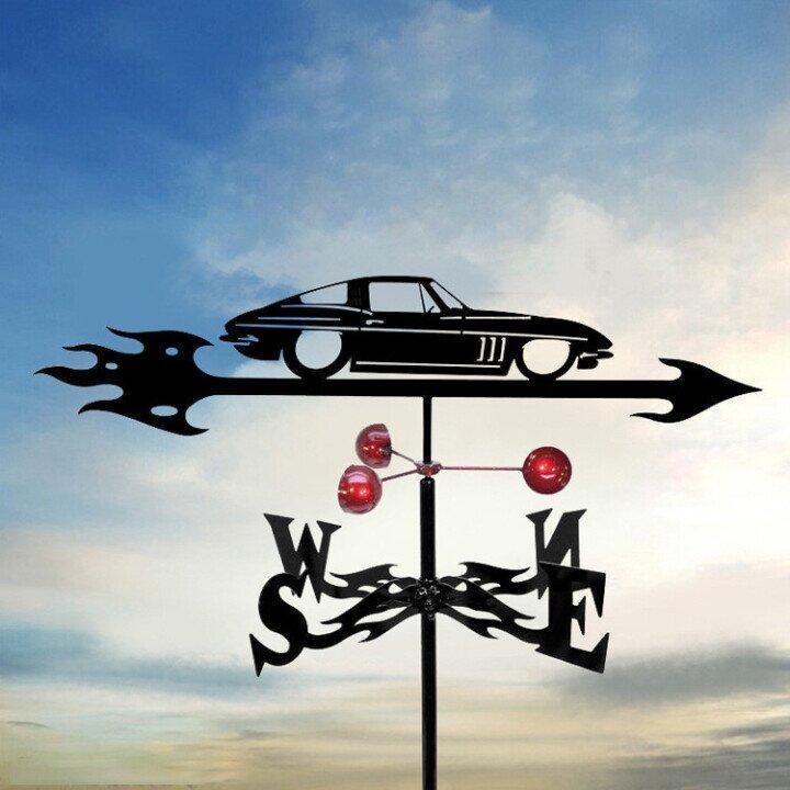 Decorative weathervane with car design against a cloudy sky