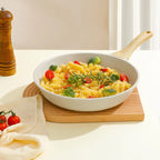 Pasta dish with vegetables in a white bowl on a wooden cutting board.