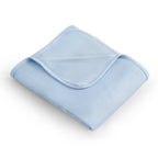 Folded light blue blanket on a white background