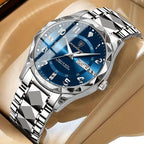Silver watch with blue dial on a beige surface