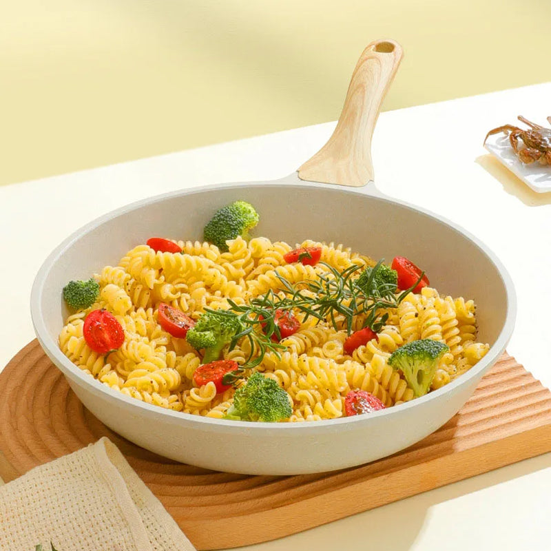 Pasta dish with vegetables in a white bowl on a wooden cutting board