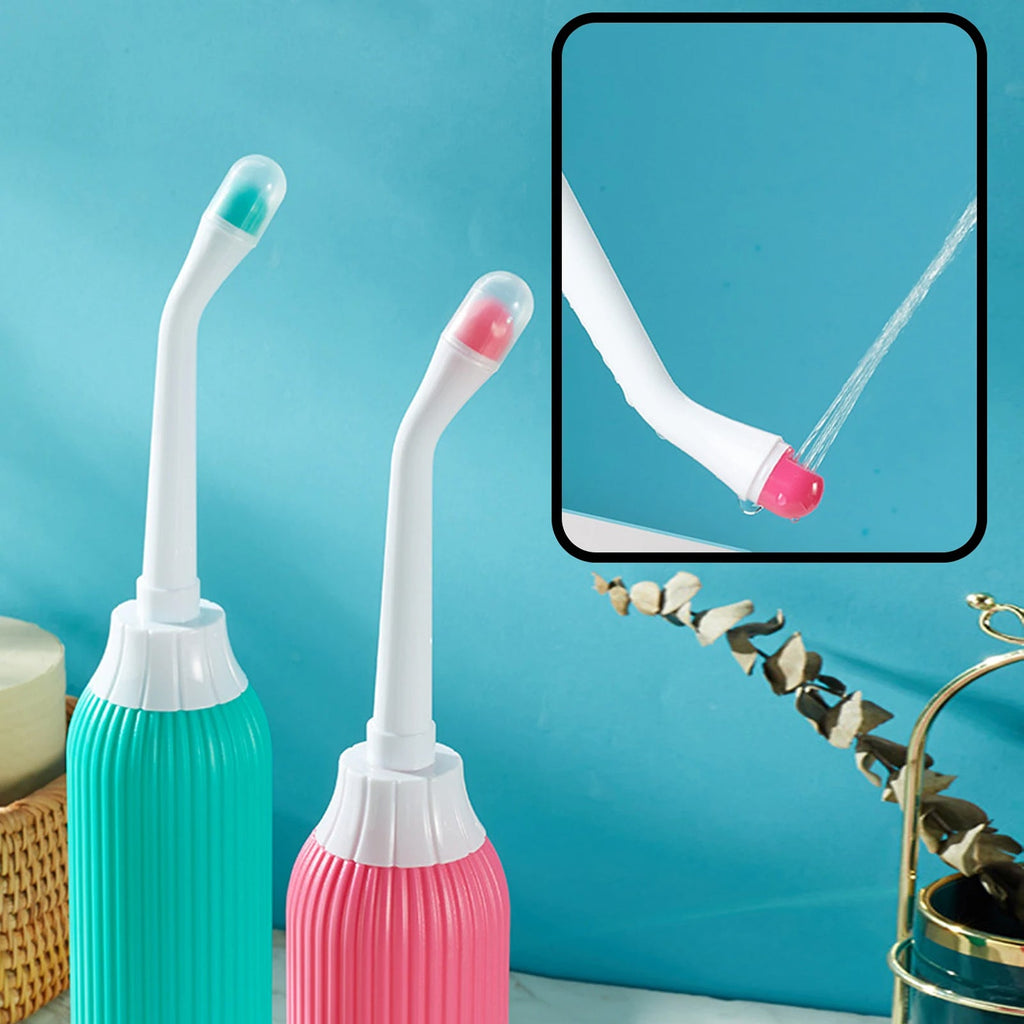 Two dental water flossers, one green and one pink, with a close-up of the nozzle on a blue background.