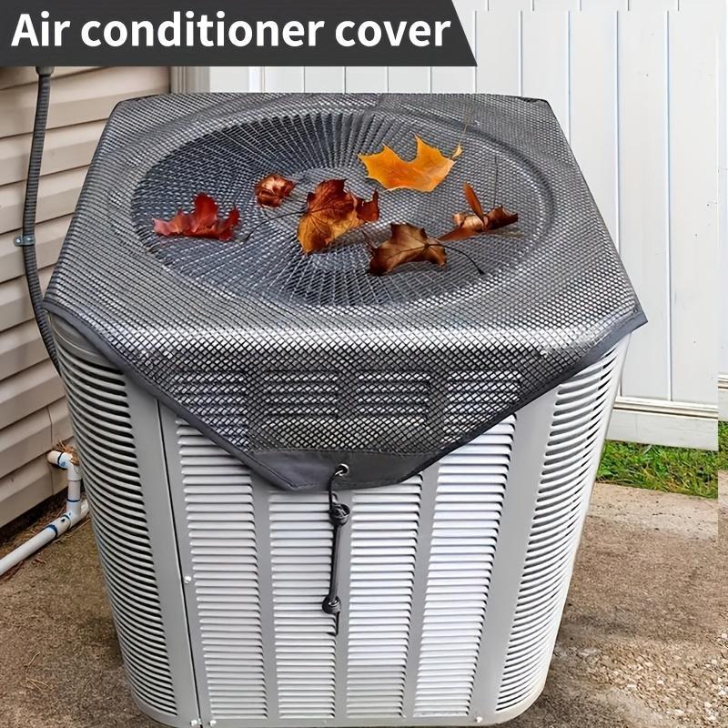 Air conditioner cover with leaves on top, placed on an outdoor air conditioning unit.