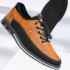 Brown and black leather shoe with brand logo on a light gray background