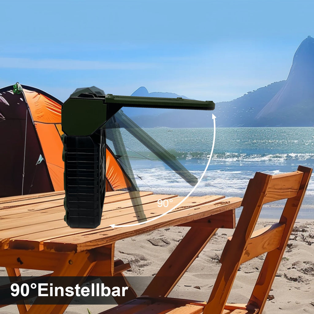 Portable table with chair on a sandy beach with ocean and mountains in the background