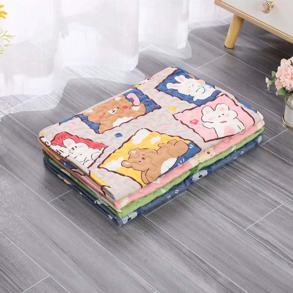 Stack of cartoon-themed folded blankets on a wooden floor with a light curtain background.