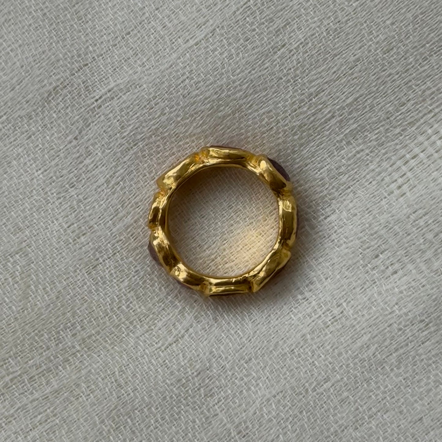22ct Gold ring with a textured surface on a gray textured background