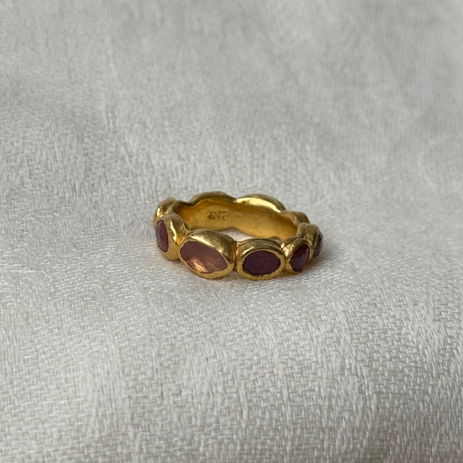 22ct Gold ring with Pink Tourmaline stones on a light gray background