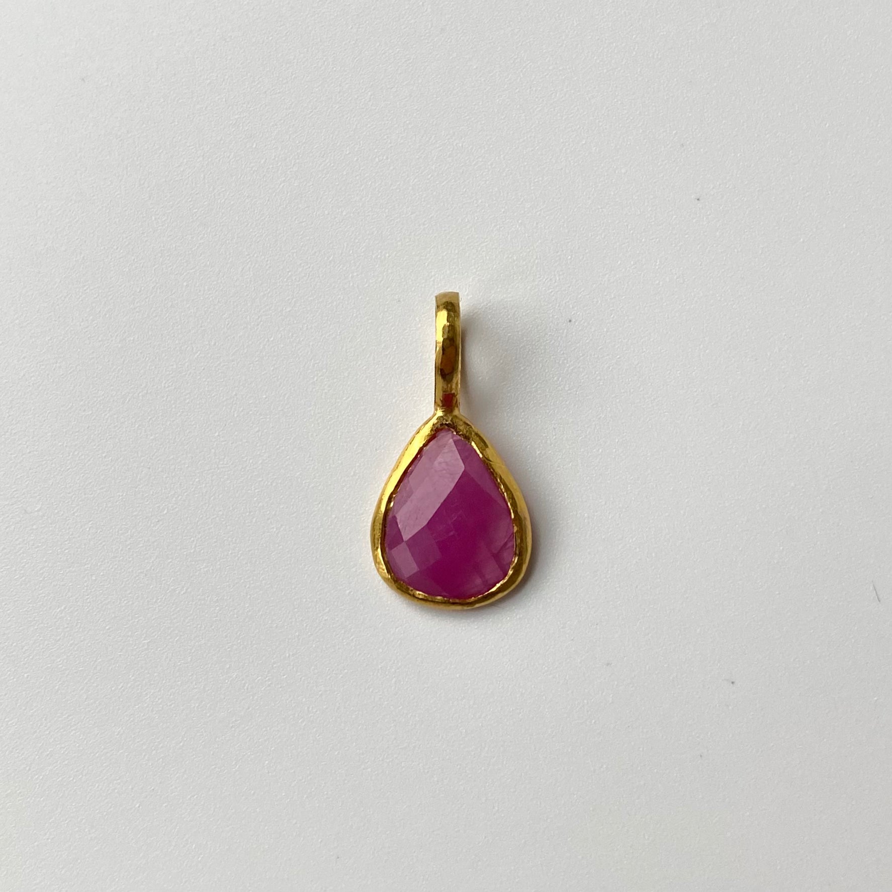 22ct Gold pendant with a pink Tourmaline teardrop-shaped gemstone on a white background
