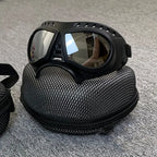 Black goggles with a textured carrying case on a gray surface