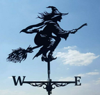 Decorative weather vane shaped like a witch on a broom against a blue sky.