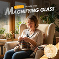 Woman sitting in a chair using a magnifying glass with text overlay about a 'Hands Free Magnifying Glass'.