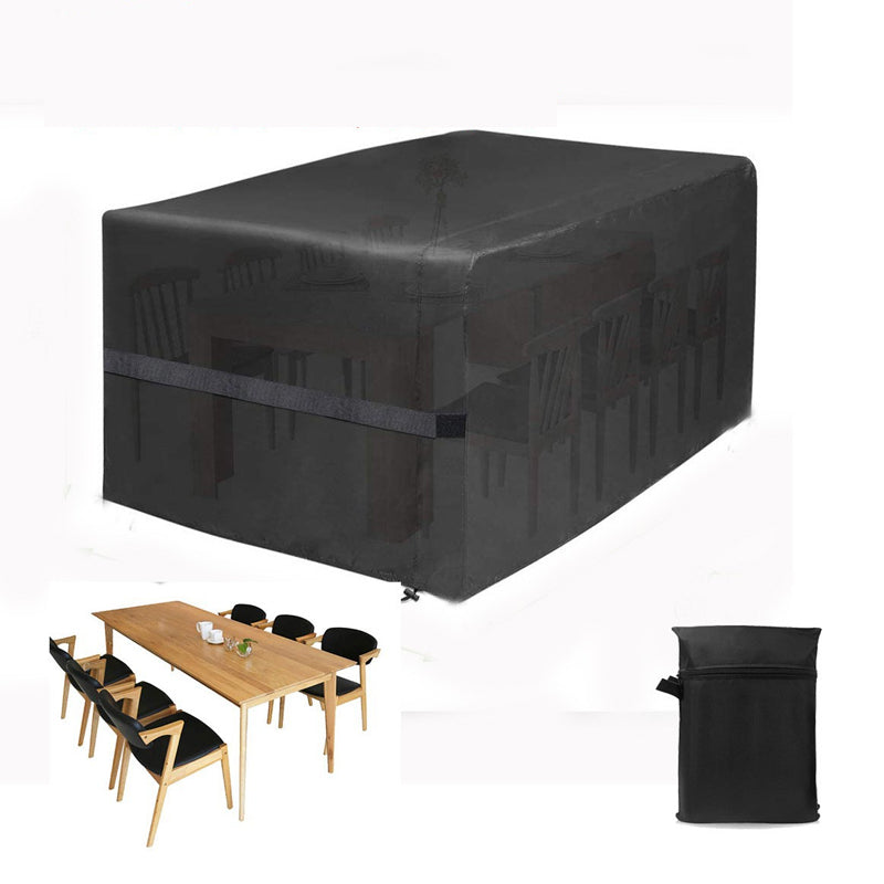 Black outdoor furniture cover with a wooden table and chairs on a white background