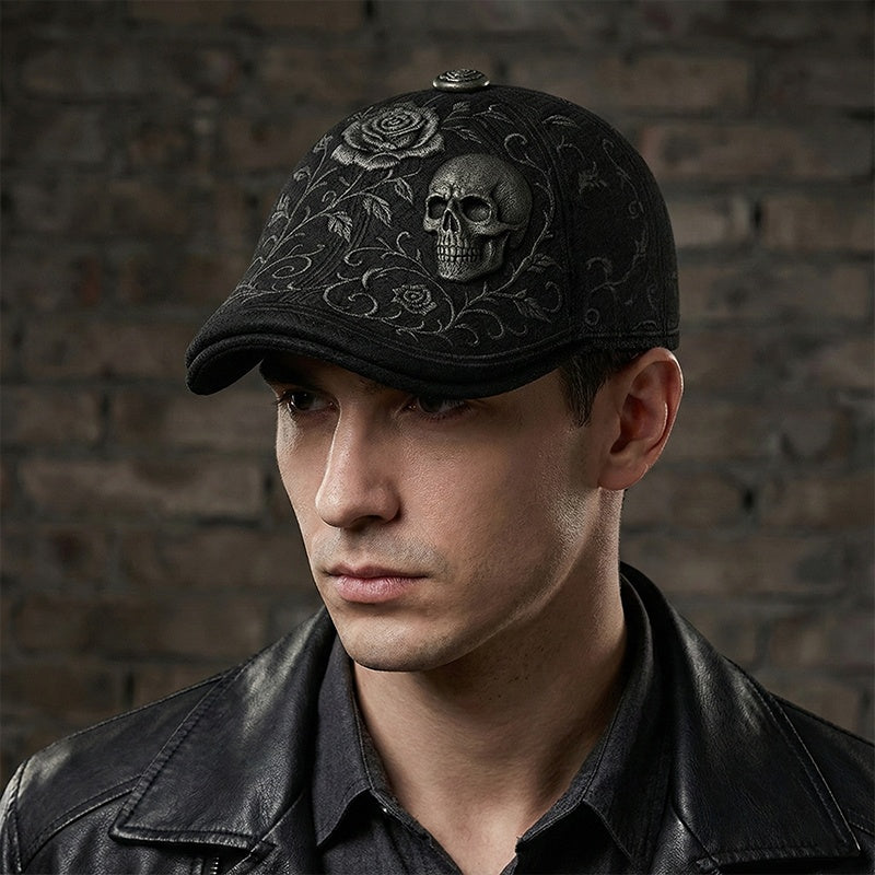 Man wearing a black cap with skull and floral design against a brick wall.