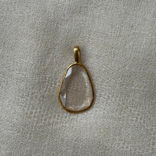 22ct Gold pendant with a clear Diamond Lab Grown stone on a textured gray background