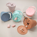 Set of colorful containers with lids on a light background