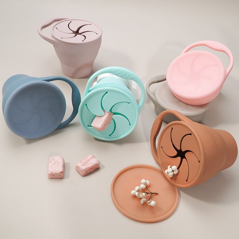Set of colorful containers with lids on a light background