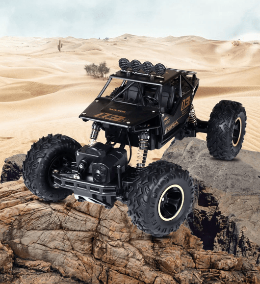 Black off-road toy vehicle on a rocky surface with desert landscape in the background