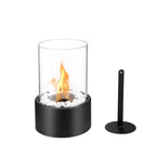 Tabletop fireplace with glass cover and black base on a white background