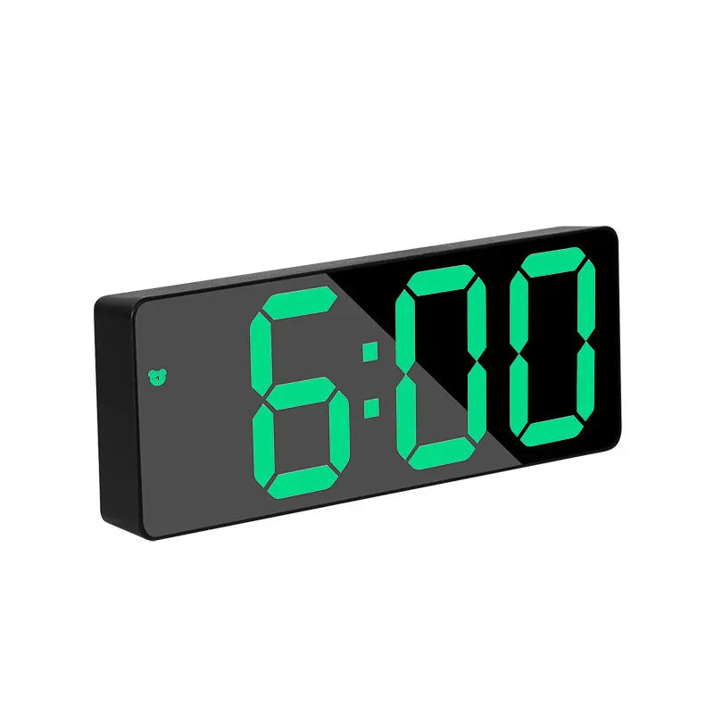 Digital clock with green LED display on a white background
