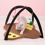 Cat playing with a pizza-shaped pet toy with hanging elements on a pink background
