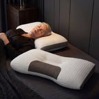 Person lying on a bed with a white and gray pillow