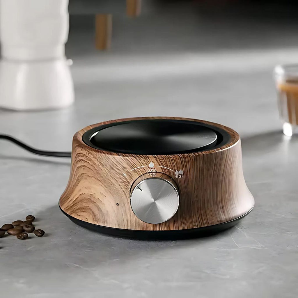 Wooden electric hot plate with a control knob on a kitchen counter.