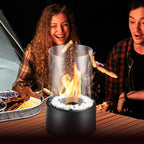 Two people roasting marshmallows over a portable fire pit at night.