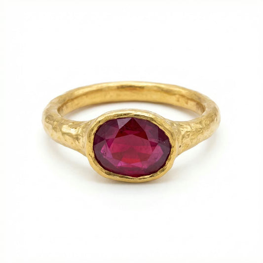 Gold 22ct handcrafted ring with a ruby gemstone on a white background