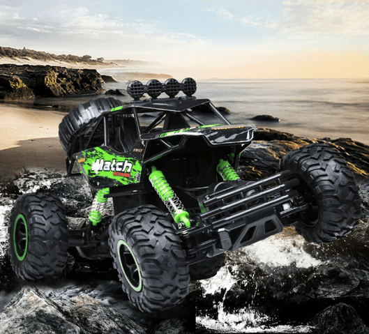 Monster truck on a rocky beach with ocean in the background