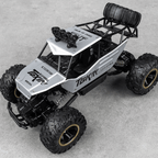 Toy truck with large wheels on a gray surface