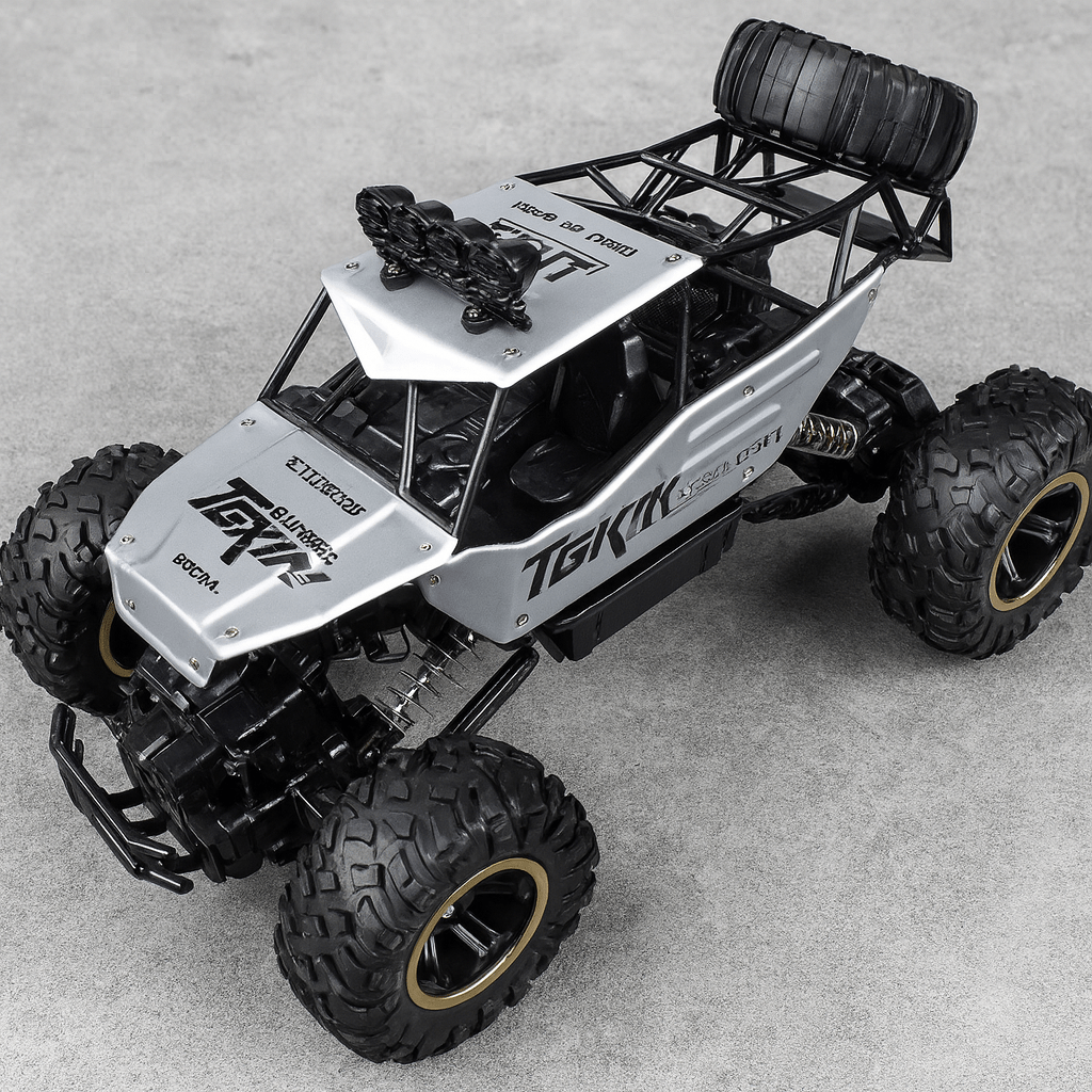 Toy truck with large wheels on a gray surface