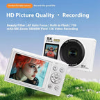 White digital camera with screen displaying a photo, on grass with blue sky background