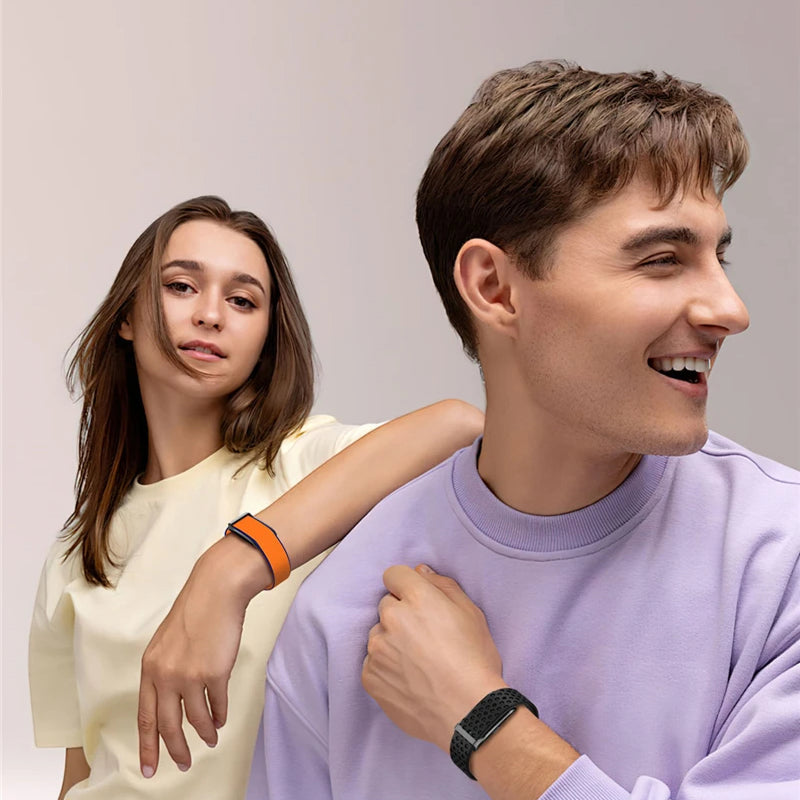 Two people standing close together with a plain background