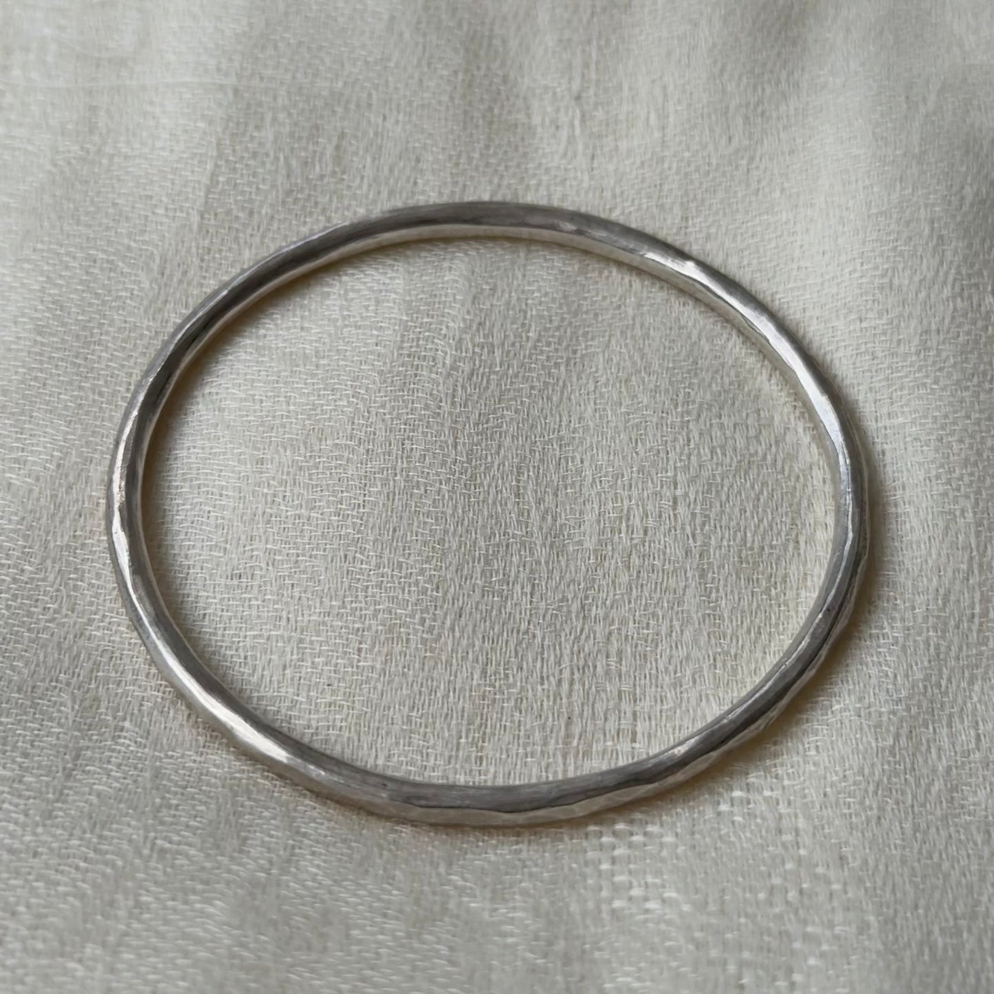 Silver bracelet with a neutral background