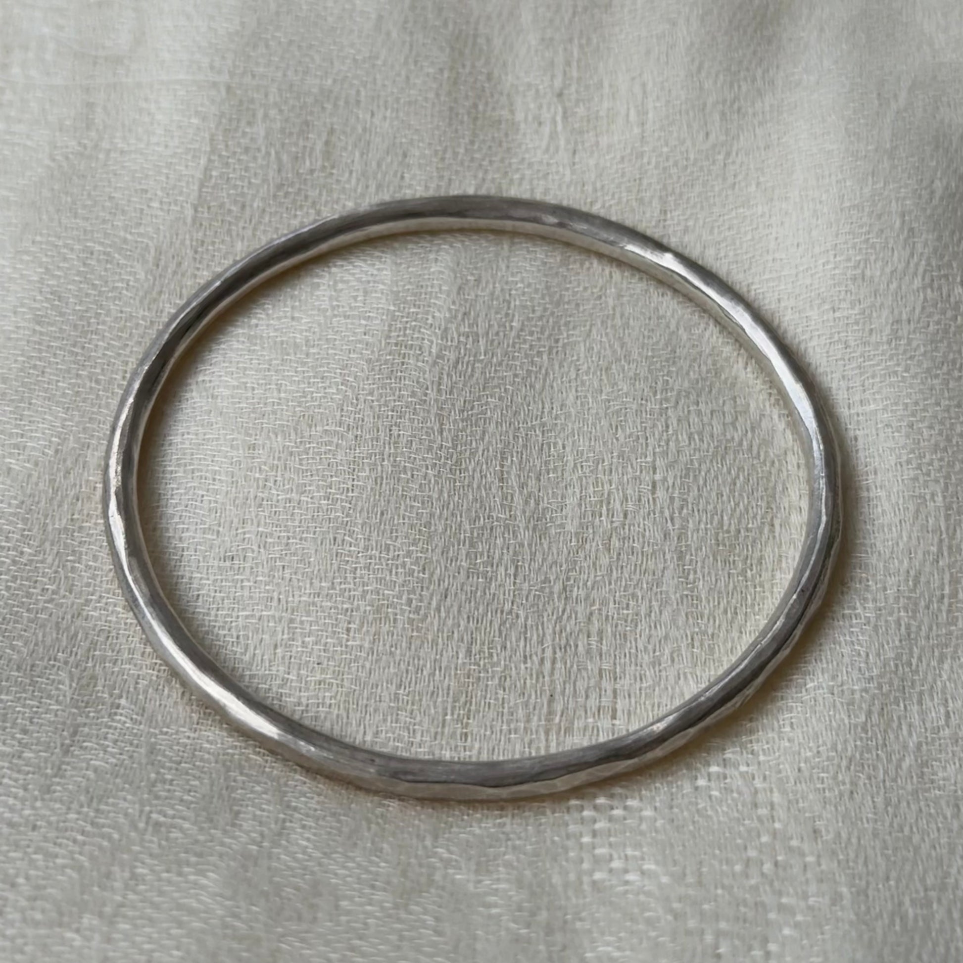 Silver bracelet with a neutral background