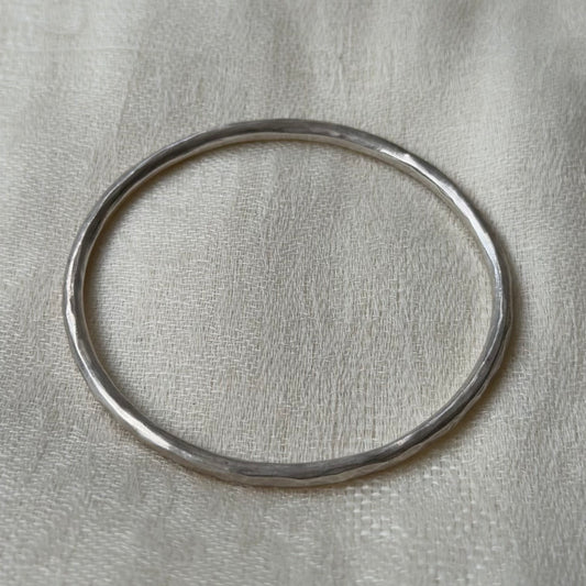 Silver bracelet with a neutral background