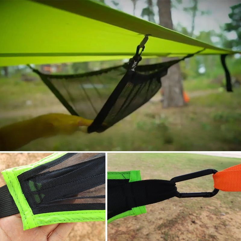 Close-up of a green hammock with mesh pocket and carabiner attachment, set against a natural outdoor background.